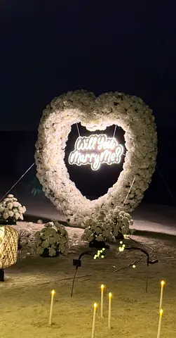 Heart-shaped White Floral Arch with Will you marry me? Neon Sign