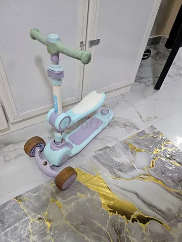 Two kids 3-wheel scooters — blue and pastel, used