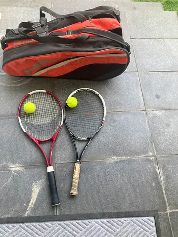Two tennis rackets with bag and balls - good condition