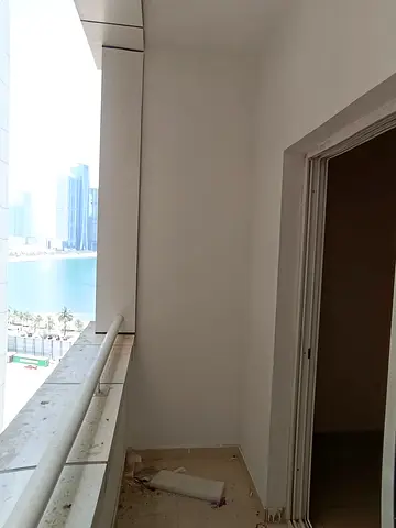 2 bedroom apartment with balcony in Al Khan Sharjah, free central AC, kitchen, 2 bathrooms, wardrobes, pool gym, parking for fee, rent 50000 AED