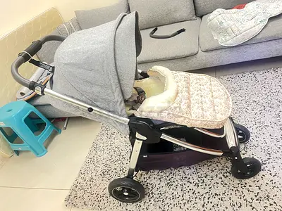 Lightweight grey travel stroller with footmuff — good condition