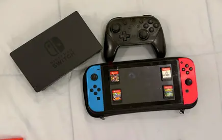 Nintendo Switch console with Pro Controller, dock, carry case and 4 game cartridges