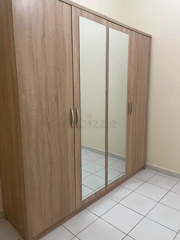 Light wood double-door wardrobe with shelves and hanging space