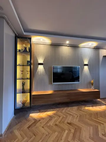 Modern wall-mounted entertainment unit with illuminated display cabinet