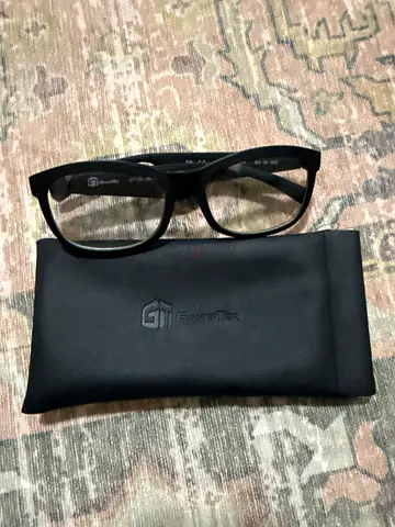 Black prescription-style glasses with soft case with a microphone and a speaker