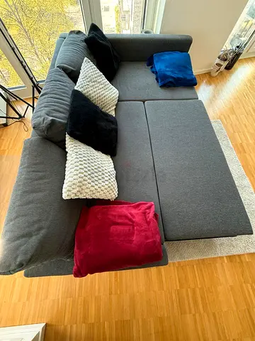 Gray L-shaped Sofa Bed with Cushions - Good Condition