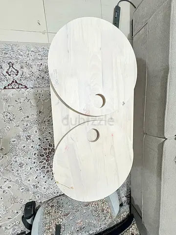 Set of two light wood nesting side/coffee tables with circular tops