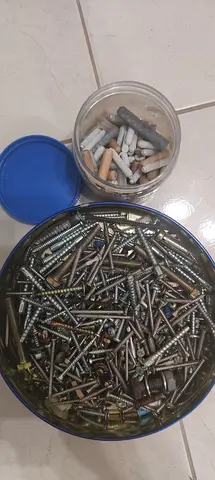 Mixed box of screws, wall plugs and fasteners - used