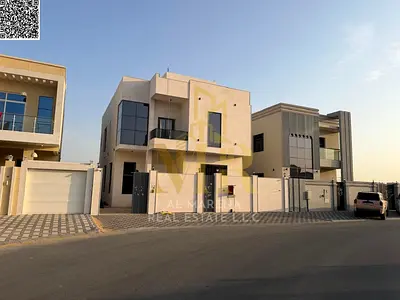 Luxury villa for sale in Al Yasmin | 3014 sq ft | Two floors + roof | 5 master bedrooms | Majlis and living room with washbasins | Modern kitchen + ma