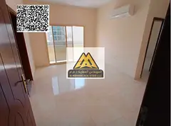 A 1-bedroom apartment with a living room for annual rent in Al Alia – Ajman, featuring a balcony a
