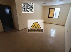 A spacious studio for annual rent in Al Alia – Ajman, featuring a semi-separate kitchen and centra