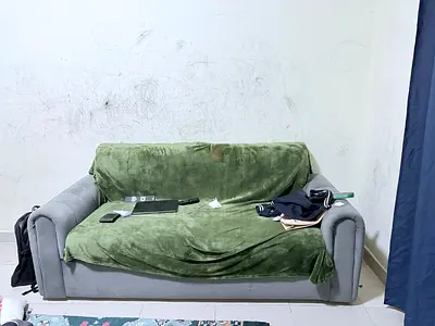 Used 3-Seater Grey Sofa with Green Throw — Good Condition
