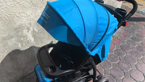 Lightweight blue stroller with sun canopy and snack tray - good condition