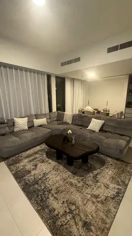 Large L-Shaped Grey Fabric Sofa with Coffee Table and Rug (Used, Good Condition)