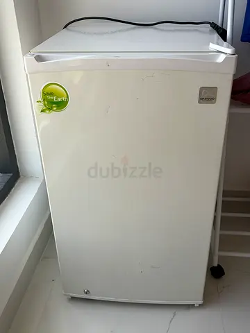 Small white single-door mini fridge