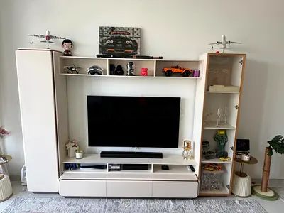 Cream modern entertainment center with storage and display cabinets