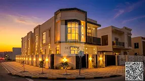 A distinctive villa for sale on a corner lot with two street frontages, opposite a park in Al Zahiya