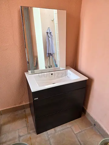 Dark wood bathroom vanity with sink and mirror - good condition