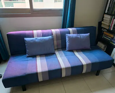 Blue striped sofa bed / futon in good condition