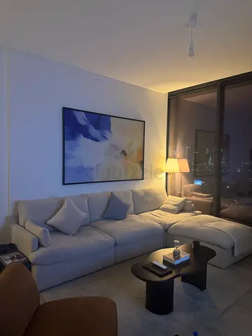 Armless Modular L-shaped fabric sofa — muted beige color, very good condition, modern design.