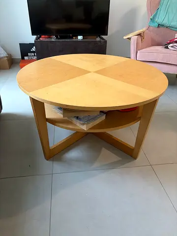 Round wooden coffee table with lower shelf - light maple finish