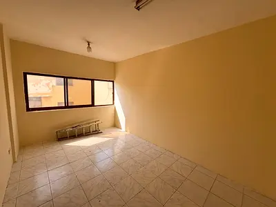 Two-bedroom apartment with a living room, spacious areas suitable for families, Sharjah Al Boutaina