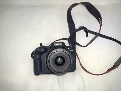 The Canon EOS R50 is a compact, entry-level APS-C mirrorless camera designed primarily for content c