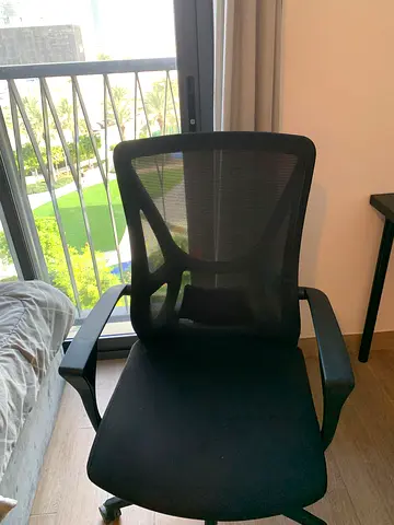 Black ergonomic mesh office chair with armrests — good condition