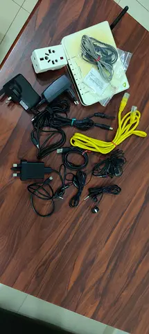 Router with assorted power adapters, cables and travel plug — used set