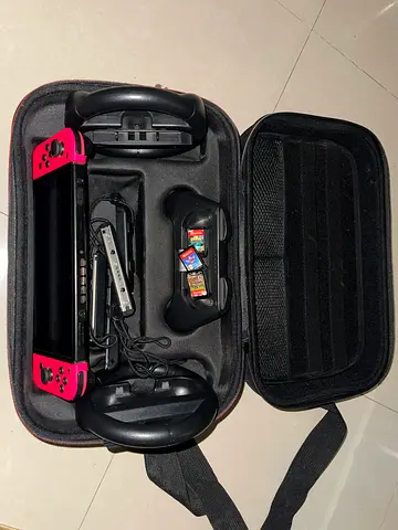Nintendo Switch console with red Joy-Con, carrying case and accessories (good condition)