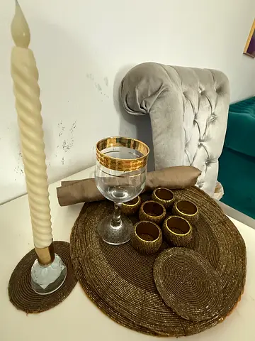 Set of woven placemats, coasters and napkin rings with decorative candle holder