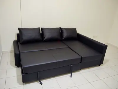 Black faux leather pull-out sofa bed with storage - good condition