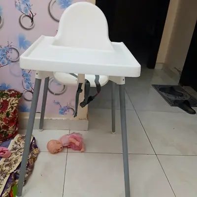 Simple white baby high chair with safety straps - good condition