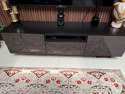 Modern low-profile TV entertainment unit in dark wood with gloss doors