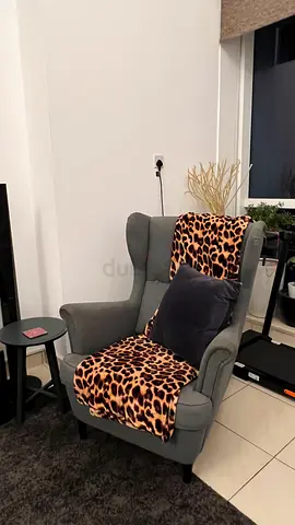 Comfortable Grey Wingback Armchair with Leopard Throw