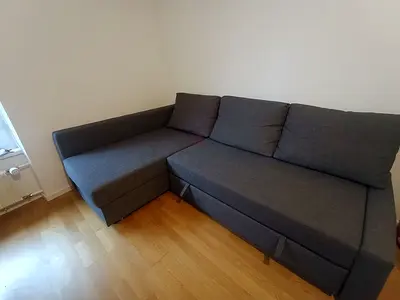 Grey L-shaped Sofa Bed - Compact Corner Couch in Good Condition
