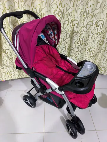 Used maroon standard baby stroller with canopy and tray