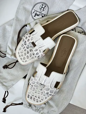 white Hermes Oran-style crocodile-embossed leather slides