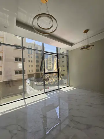 Two bedroom first tenant apartment with living room and two bathrooms in Al Hamidiyah spacious layout prime location near services and schools code B2