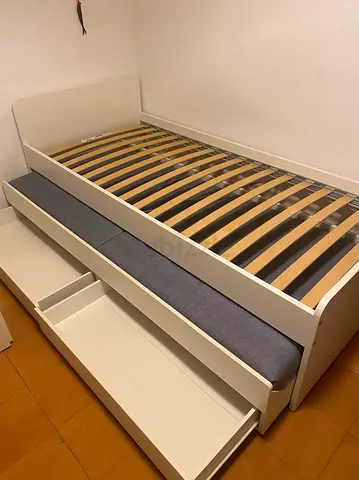 White wooden single trundle bed with storage drawers
