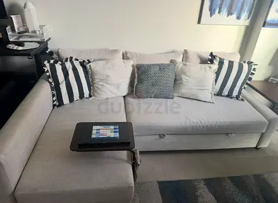Beige L-shaped fabric sofa with chaise storage - good condition