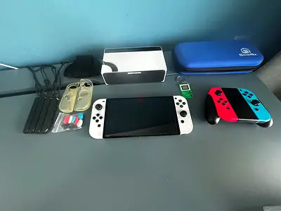 White Nintendo oled with multiple games accessories and case and protective gear CASH ONLY!!