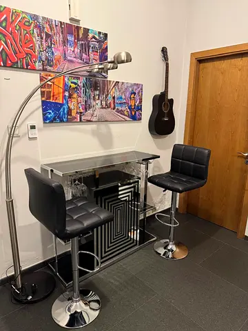 Compact mirrored home bar with two adjustable swivel stools