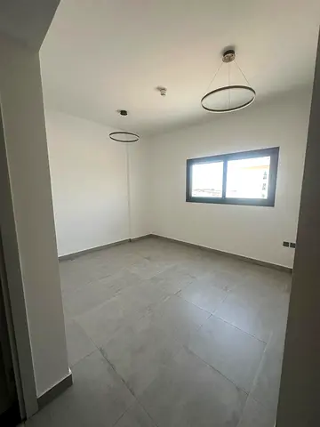 Luxury one-bedroom apartment in Tilal Al Taawun, Sharjah, available for annual rent. First occupancy. Features include central air conditioning, built