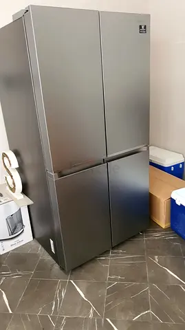 Silver 4-Door Refrigerator - Stainless Finish, Good Condition