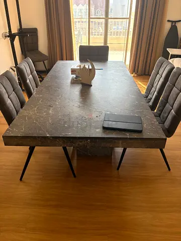 Modern dark marble dining table with 6 upholstered chairs