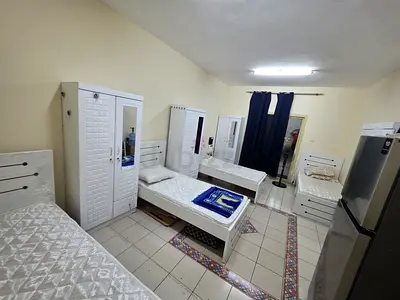 Bed space with a balcony with a fridge