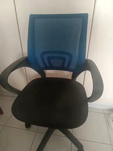 Used ergonomic office chair with blue mesh back