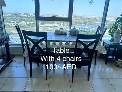 Dining table with 4 chairs - good condition, 100 AED