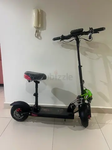 Electric Scooter with Seat — Good Condition, Includes Lock and Charger less than a year old and har.